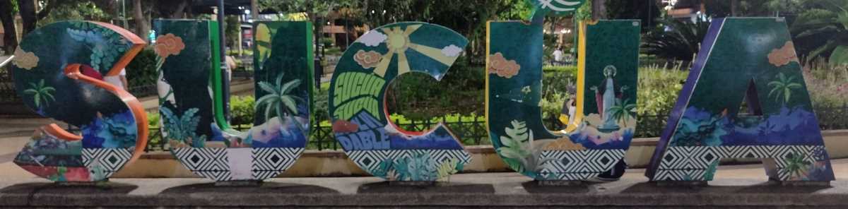 sucua-sign.jpg The city name sign is in Parque Central.