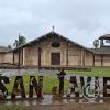 City name sign in front of Mision de San Francisco Xavier