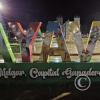 City name sign in the Plaza de Armas at night